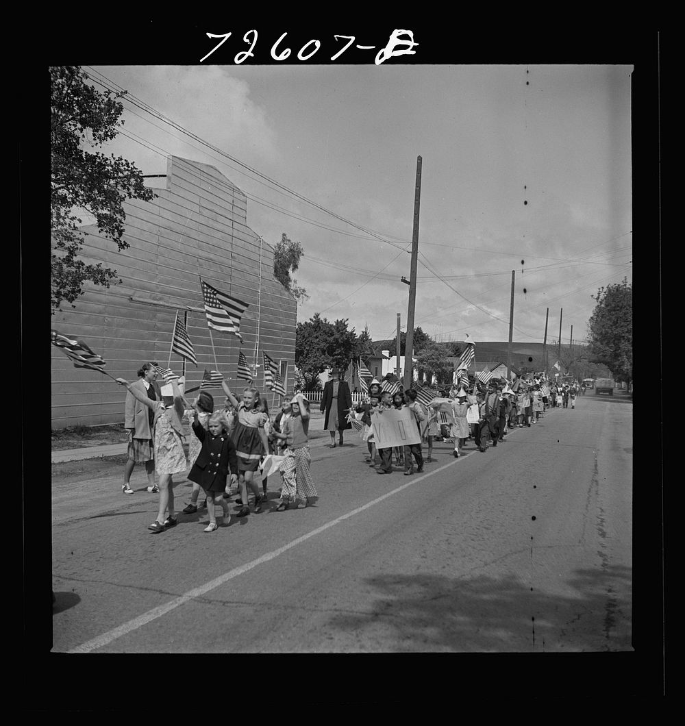 San Juan Bautista, California. Schoolchildren marching with scrap metal they have collected for the war by Russell Lee