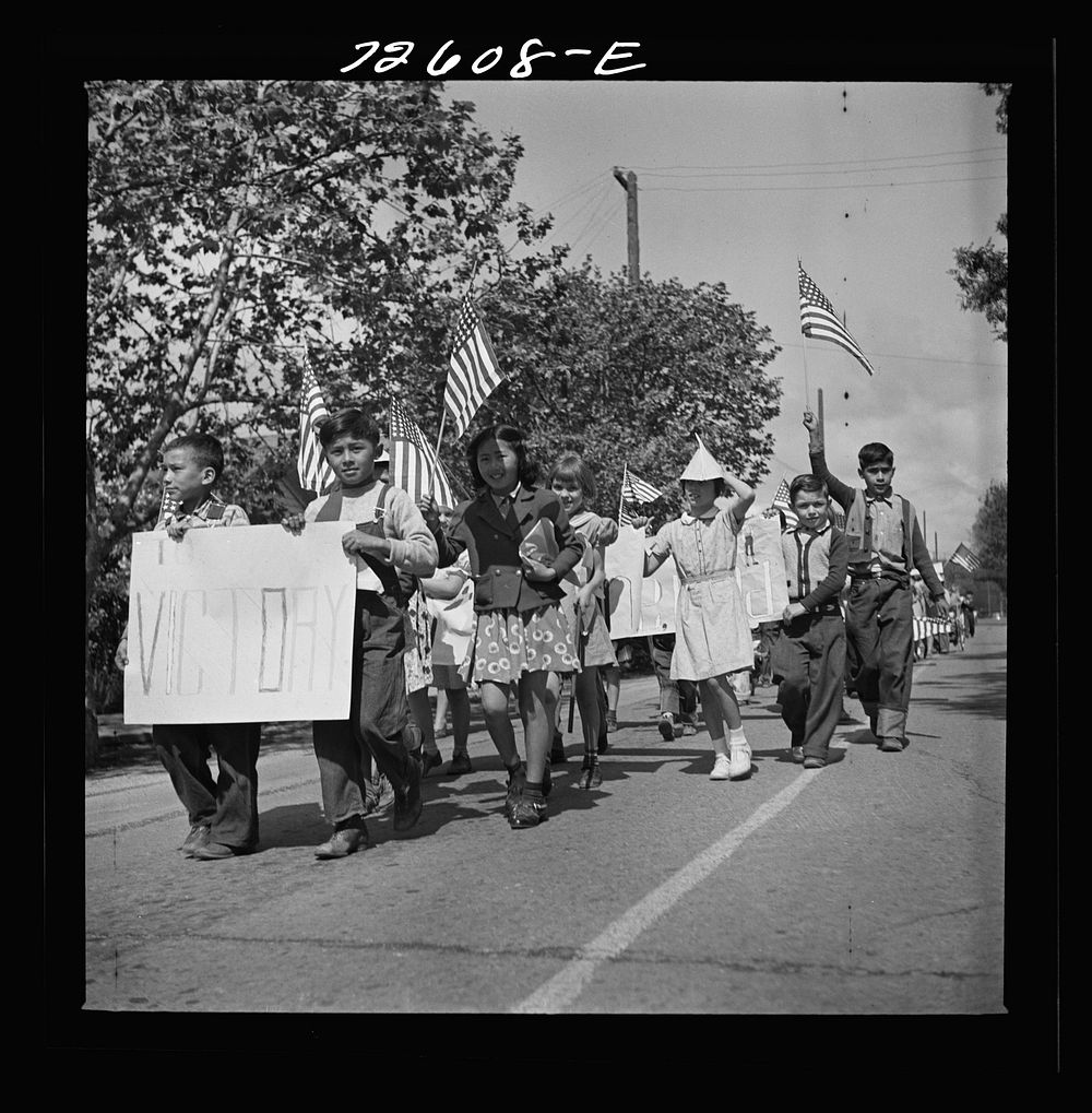 San Juan Bautista, California. Schoolchildren marching with scrap metal for the war by Russell Lee