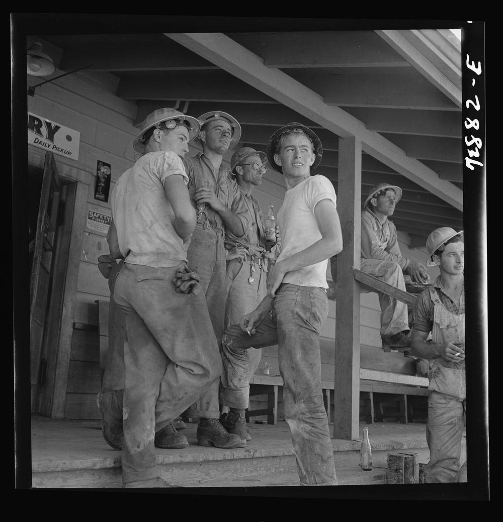 Shasta Dam, Shasta County, California. Workman on the porch of the commissary by Russell Lee