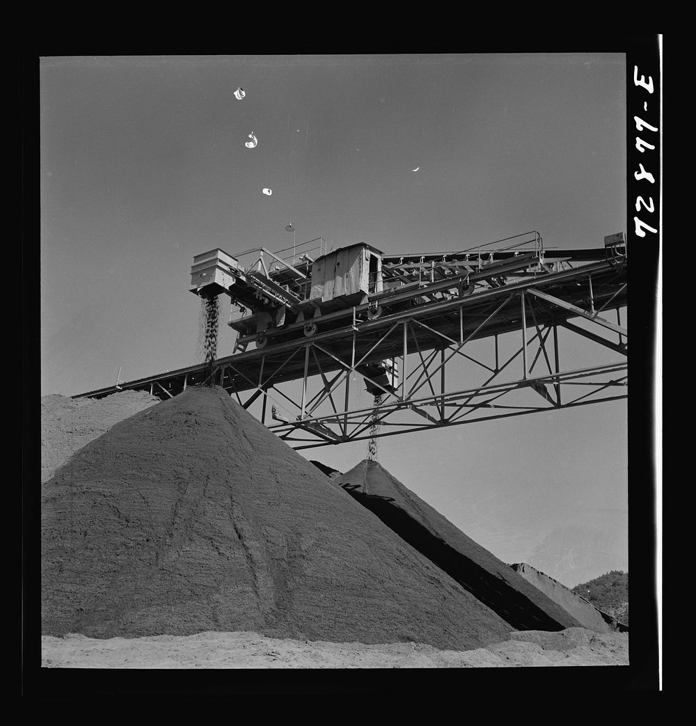 Shasta Dam, Shasta County, California. Pile of gravel under conveyor belt. The gravel will be used in construction of the…