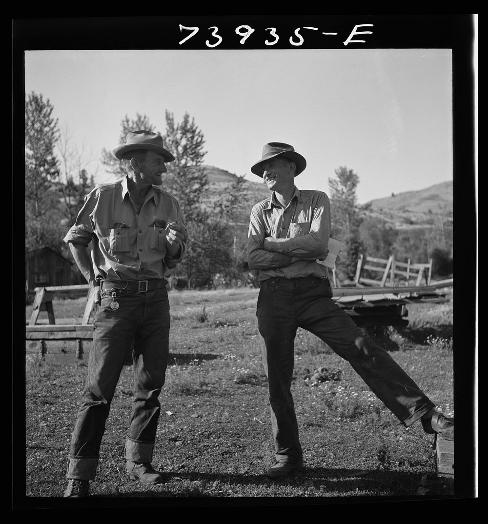 Ola, Idaho. Member of the Ola self-help cooperative talking to a customer of the cooperative sawmill by Russell Lee