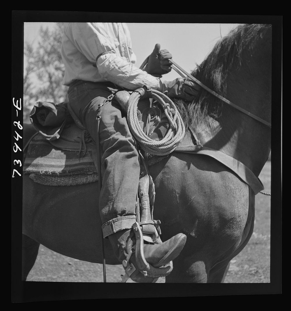 Ola, Idaho. Detail of cowboy on horseback by Russell Lee