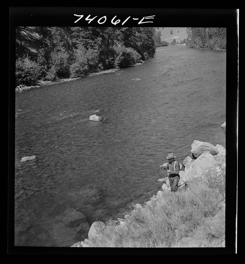 [Untitled photo, possibly related to: Custer County, Idaho. Fisherman with his dog on the Salmon River] by Russell Lee
