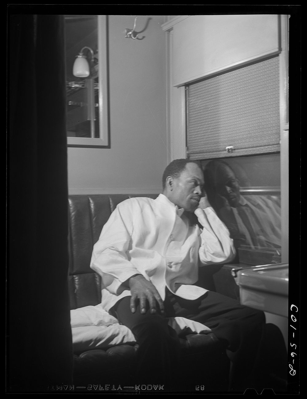 Alfred MacMillan, Pullman porter resting in the men's washroom aboard the "Capitol Limited" bound for Chicago, Illinois.…