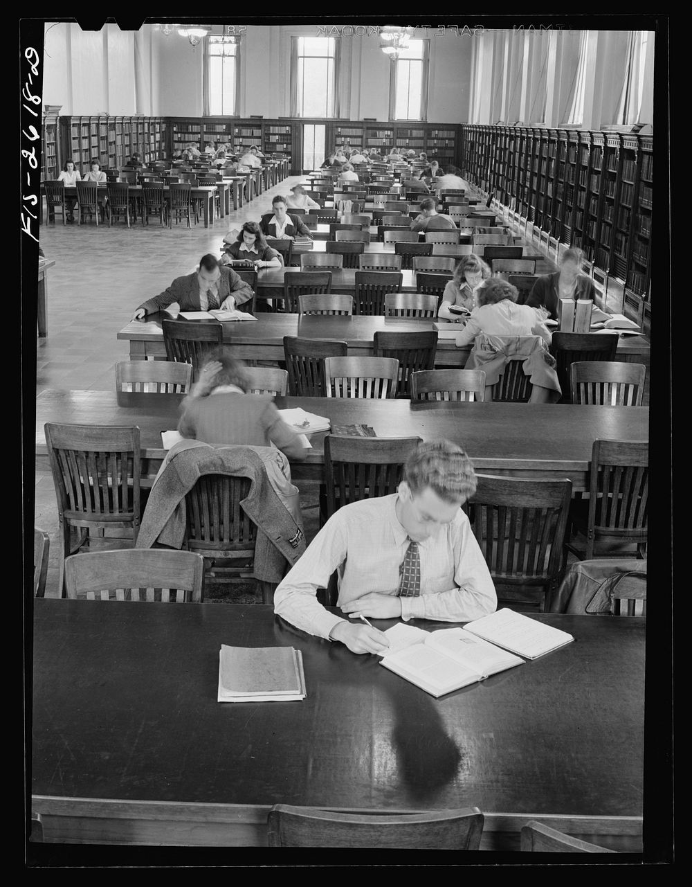 [Untitled photo, possibly related to: In the library at Iowa State College. Ames, Iowa]. Sourced from the Library of…