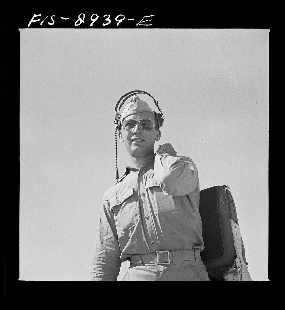 Lieutenant of interceptor squadron walking to airplane. Lake Muroc, California by Russell Lee