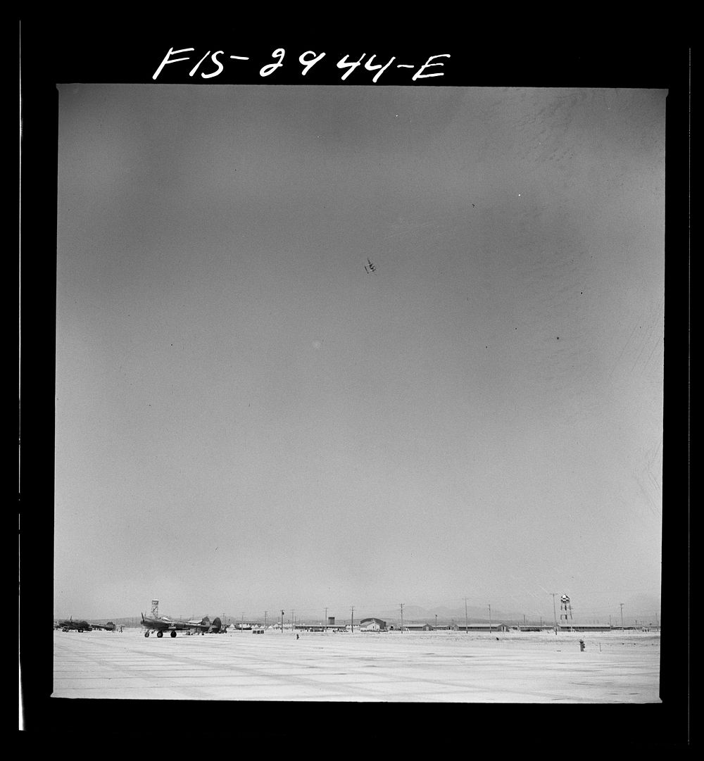 [Untitled photo, possibly related to: "Buzzing" the field. Member of interceptor squadron swoops low over parked airplanes…