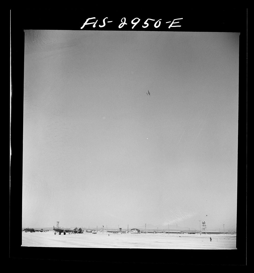 [Untitled photo, possibly related to: "Buzzing" the field. Member of interceptor squadron swoops low over parked airplanes…