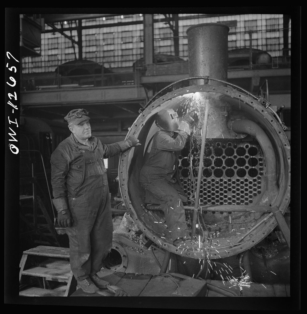 Chicago, Illinois. Working on a locomotive at the Chicago and Northwestern Railroad shops. Sourced from the Library of…