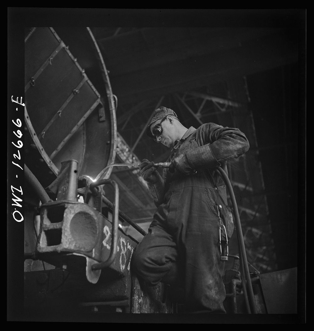 Chicago, Illinois. Cutting a metal part for a locomotive at the Chicago and Northwestern Railroad repair shops. Sourced from…
