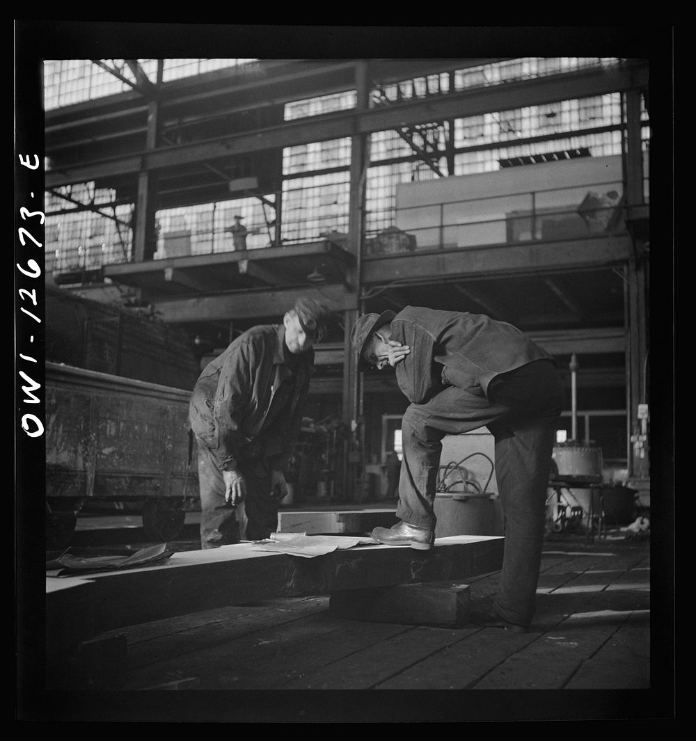 [Untitled photo, possibly related to: Chicago, Illinois. Workmen studying blueprints in the Chicago and Northwestern…
