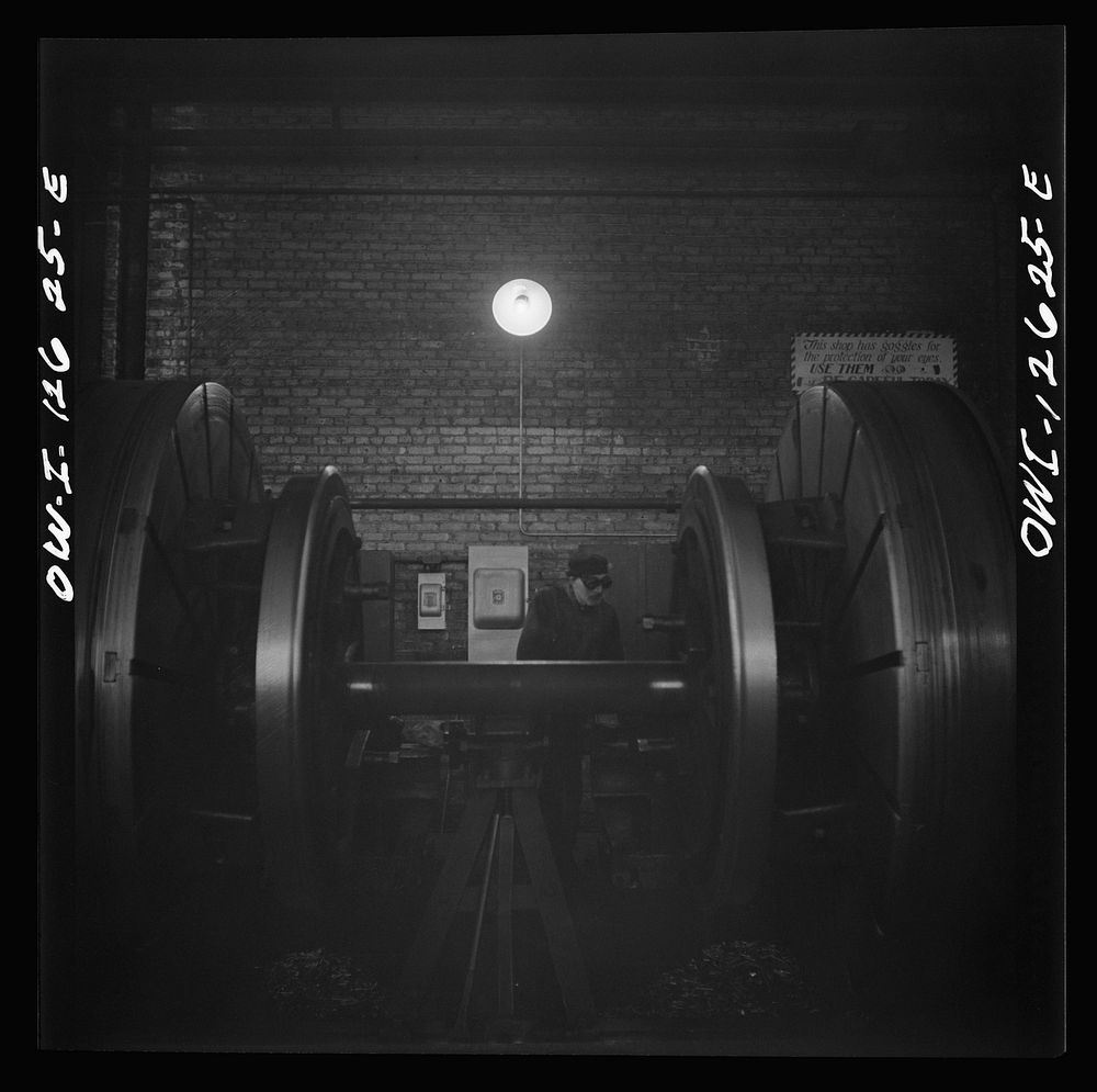Chicago, Illinois. Refacing tires on locomotive's wheels at a Chicago and Northwestern Railroad shop. Sourced from the…