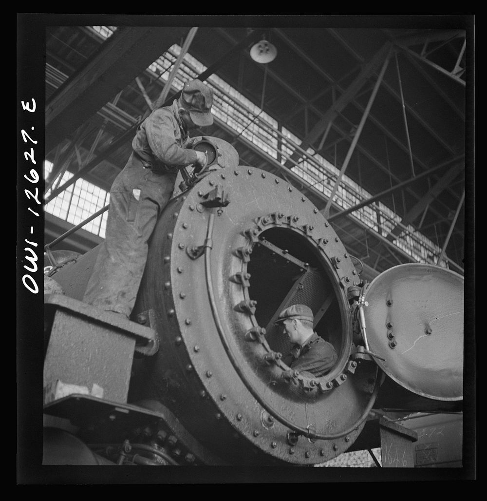 Chicago, Illinois. Working on a locomotive at the Chicago and Northwestern Railroad repair shops. Sourced from the Library…