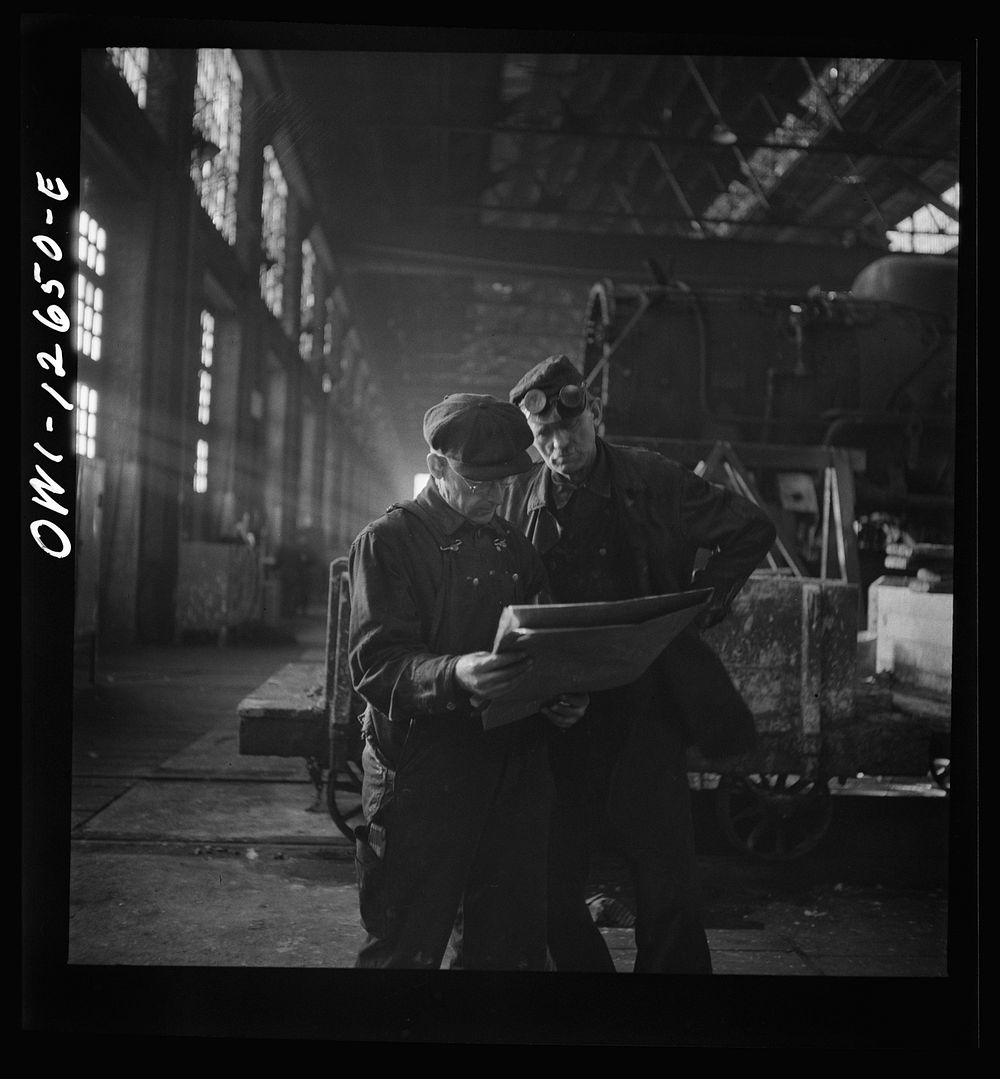 [Untitled photo, possibly related to: Chicago, Illinois. Workmen studying blueprints in the Chicago and Northwestern repair…