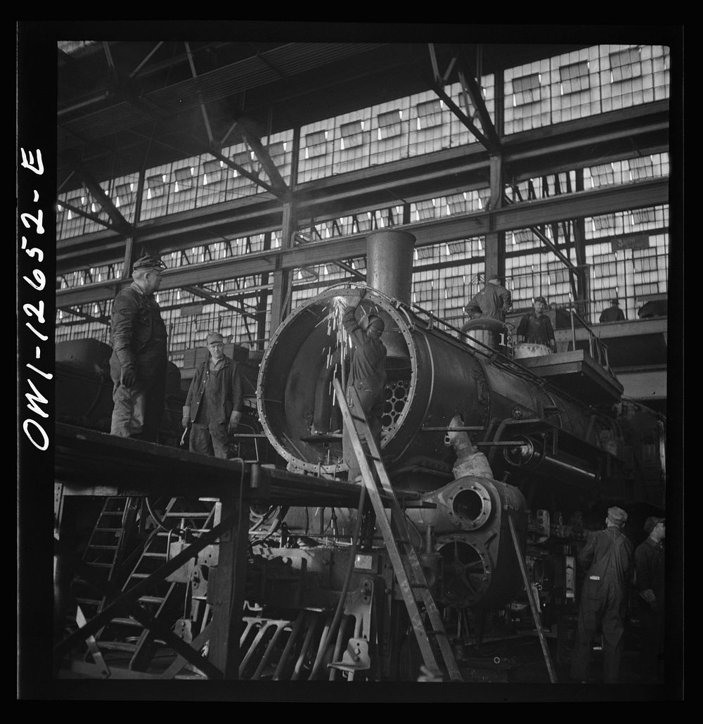 [Untitled photo, possibly related to: Chicago, Illinois. Working on a locomotive at the Chicago and Northwestern Railroad…