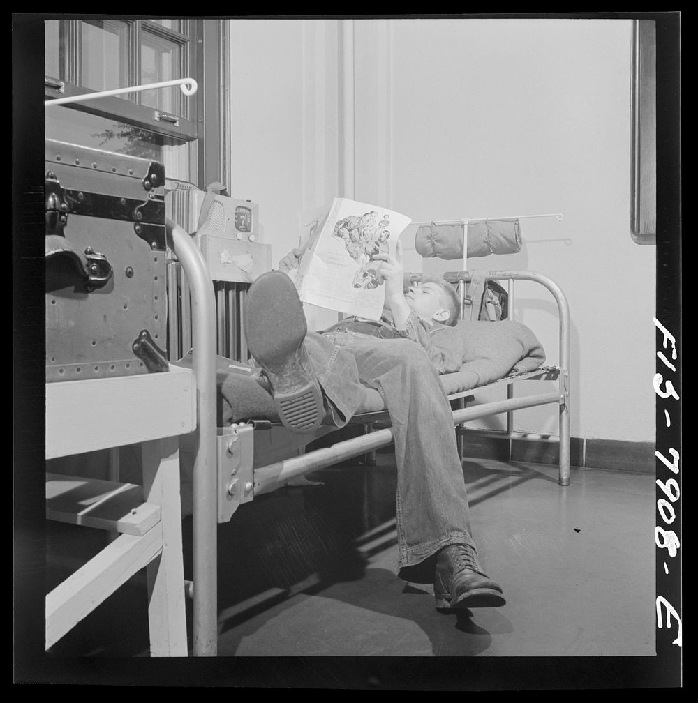 [Untitled photo, possibly related to: Fort Belvoir, Virginia. Sergeant George Camblair reading an article in a magazine…