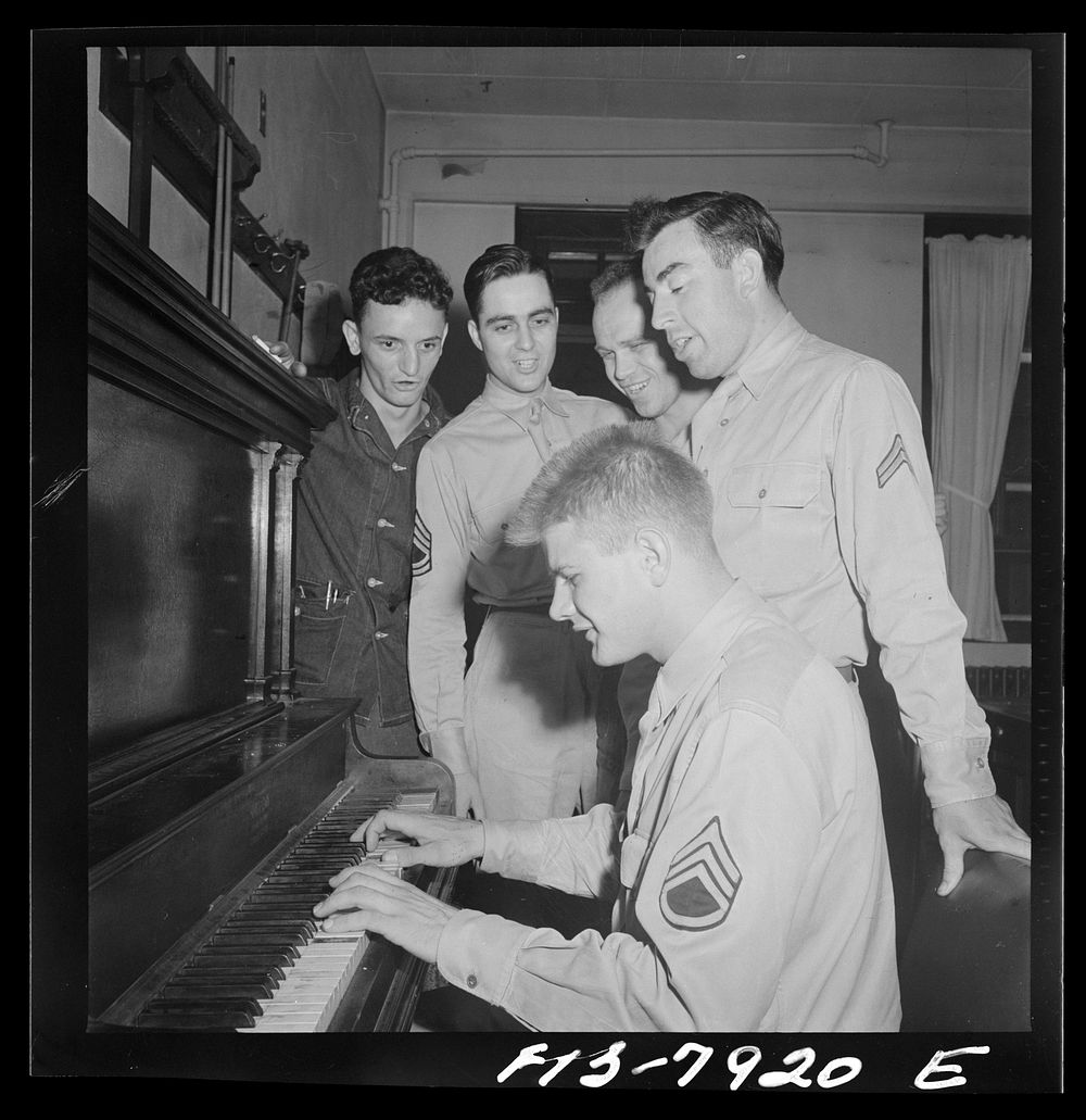 [Untitled photo, possibly related to: Fort Belvoir, Virginia. Sergeant George Camblair is taught how to play "chopsticks" on…