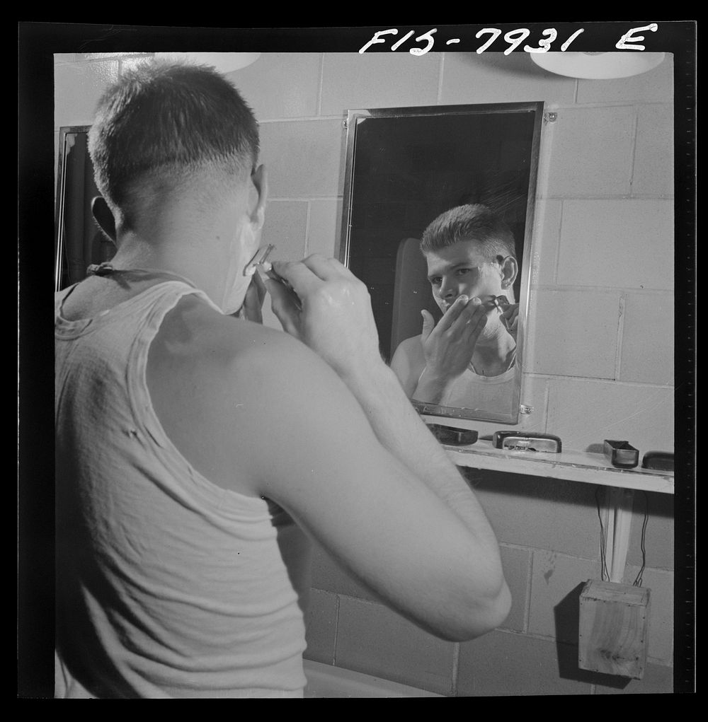 Fort Belvoir, Virginia. Sergeant George Camblair shaving in the morning at the camp. Sourced from the Library of Congress.