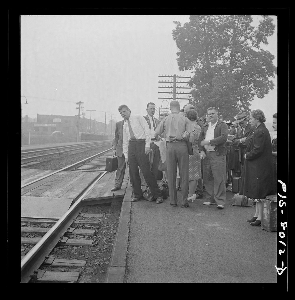 Silver Spring, Maryland. George Camblair waiting at the station for the train which will take him to the induction center.…