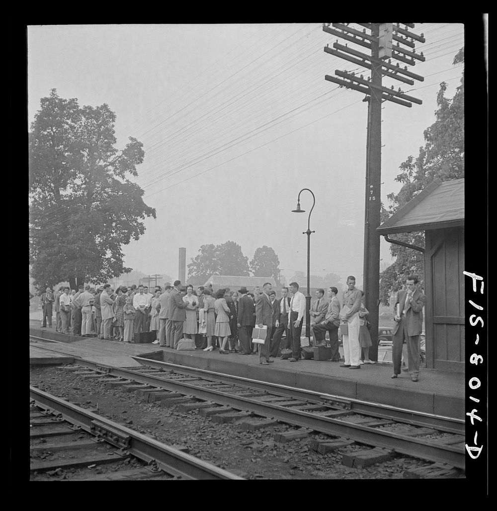 [Untitled photo, possibly related to: Silver Spring, Maryland. George Camblair waiting at the station for the train which…