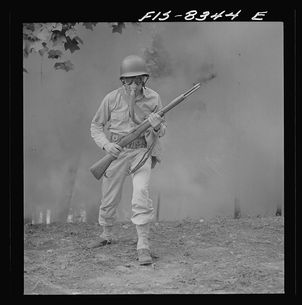 [Untitled photo, possibly related to: Fort Belvoir, Virginia. Sergeant George Camblair learning how to use a gas mask in a…