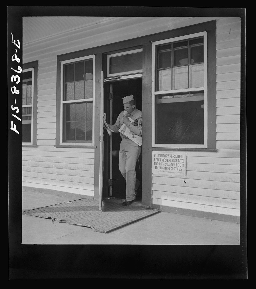Fort Belvoir, Virginia. Sergeant George Camblair getting some magazines and an ice-cream cone at the post exchange. Sourced…
