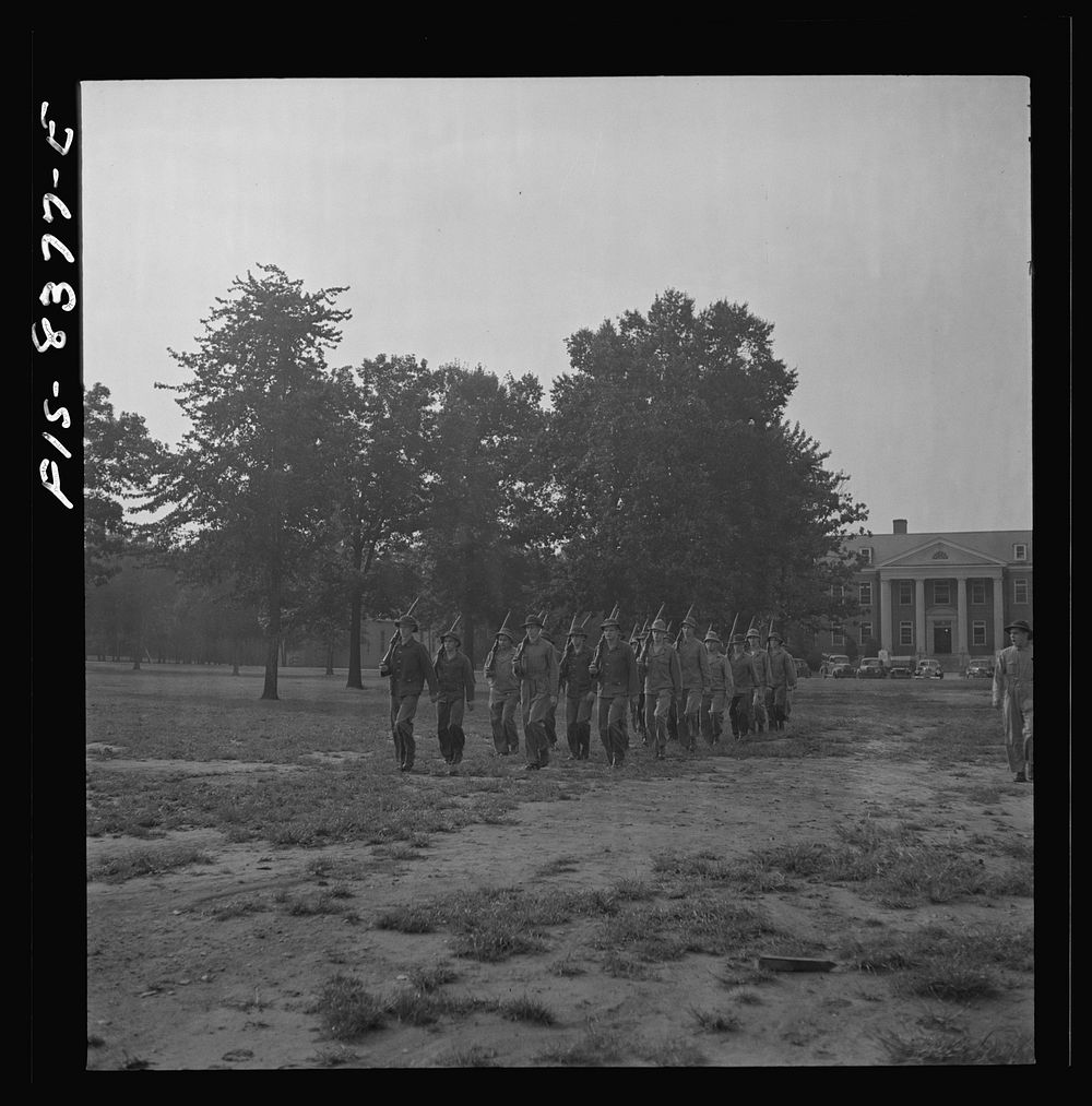 [Untitled photo, possibly related to: Fort Belvoir, Virginia. Sergeant George Camblair drilling with the rest of his…