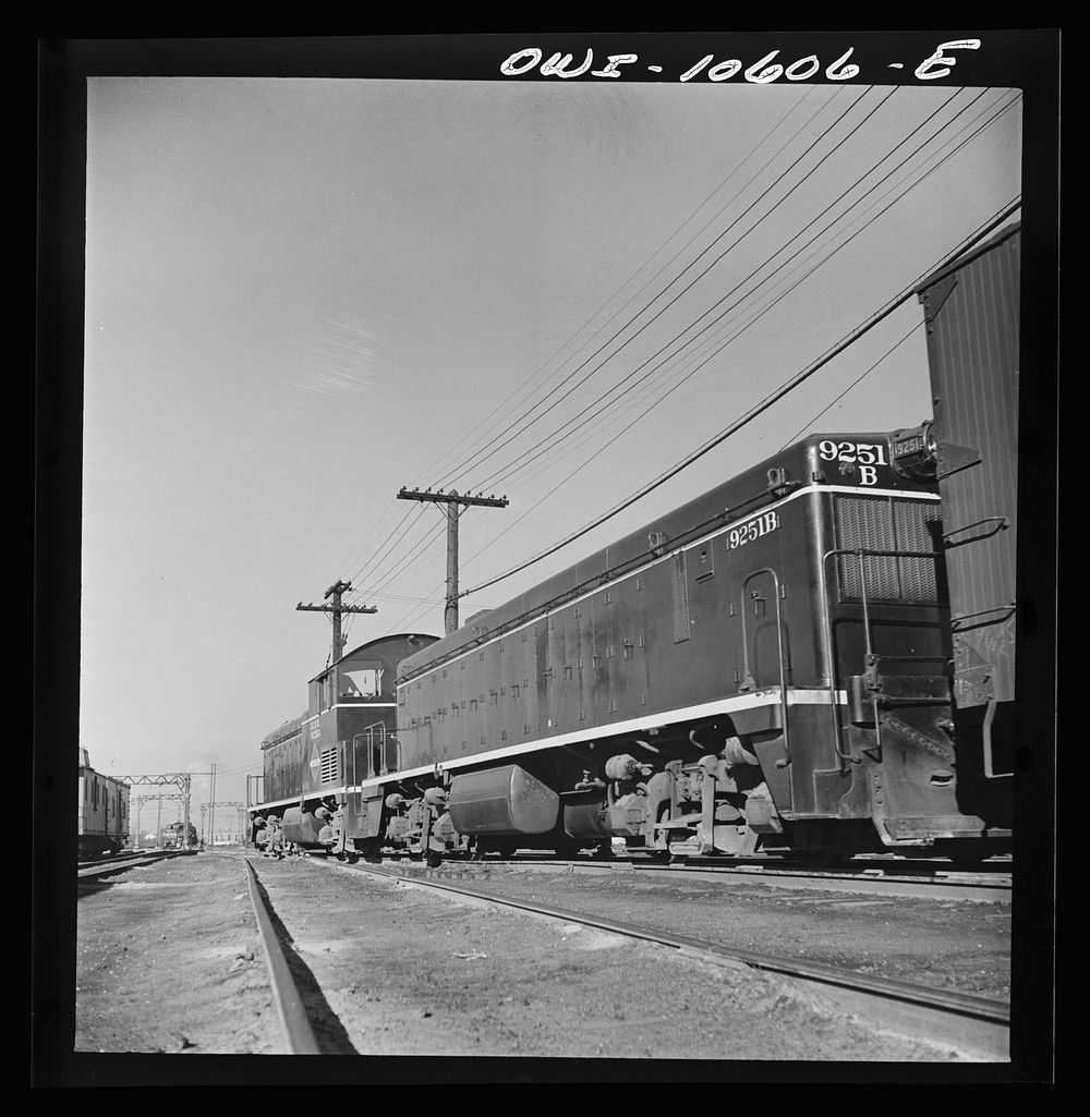 Chicago, Illinois. One of the giant diesel-electric locomotives at work at an Illinois Central Railroad yard. Sourced from…