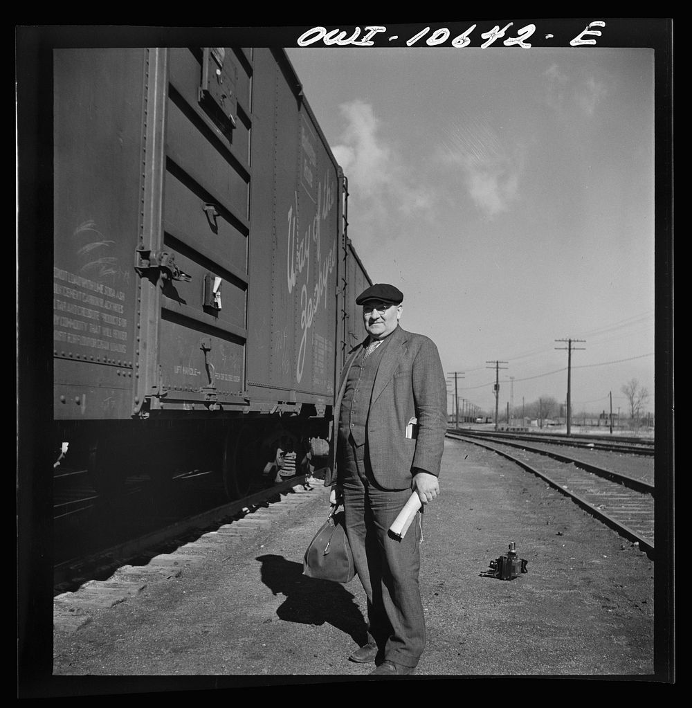 Chicago, Illinois. Conductor waiting to hop aboard the caboose of a southbound freight at an Illinois Central Railroad yard.…