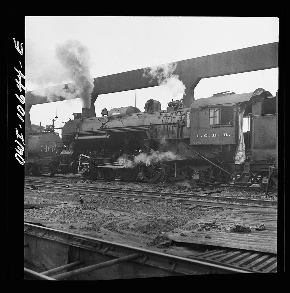 Chicago, Illinois. Locomotive taking on sand at an Illinois Central Railroad yard, before going out on the road. Sourced…