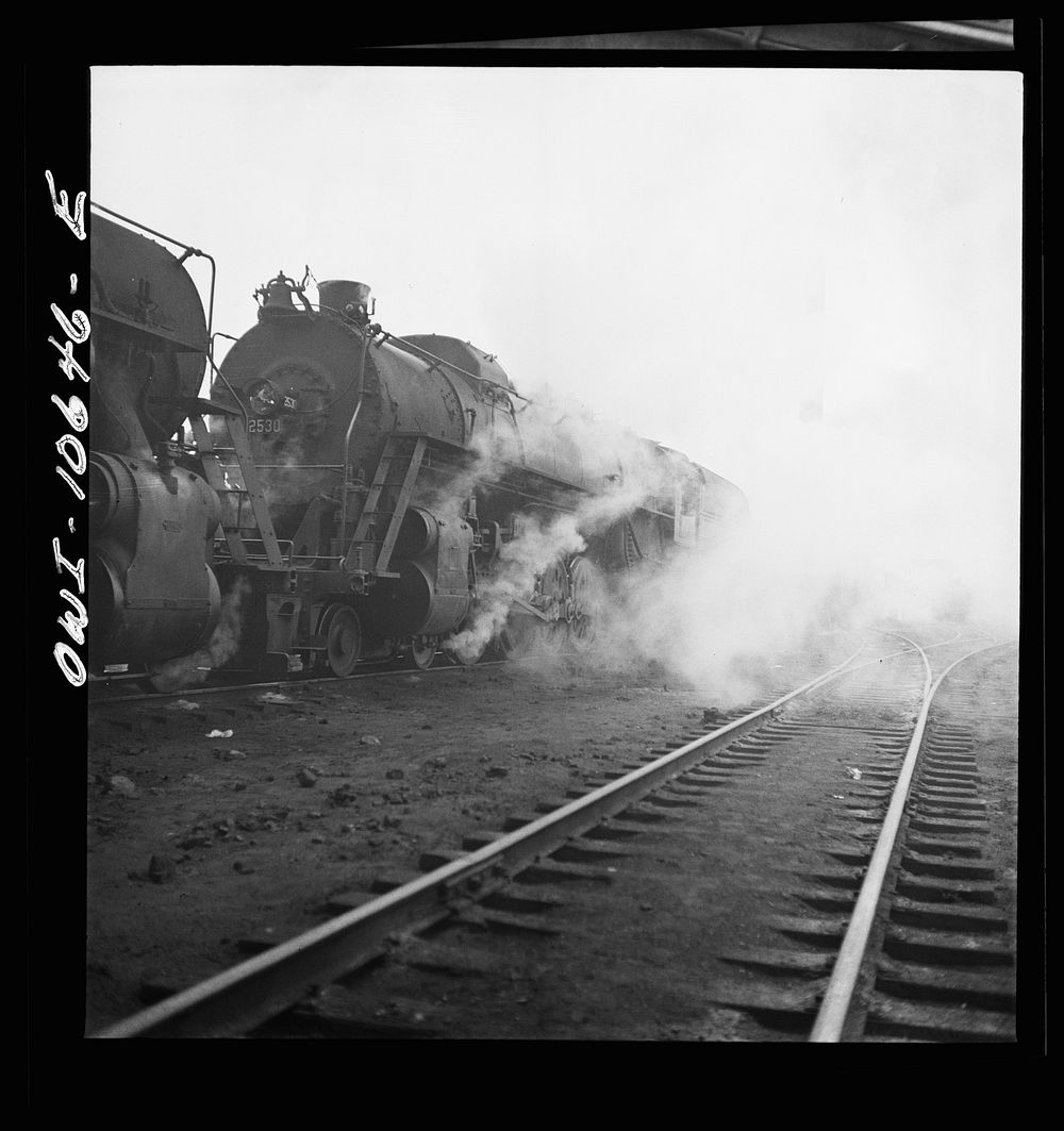 [Untitled photo, possibly related to: Chicago, Illinois. Washing a locomotive at the coaling station at an Illinois Central…