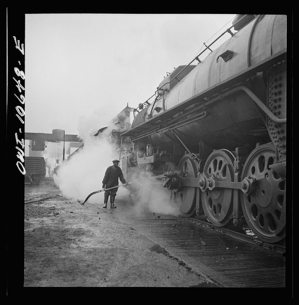 Chicago, Illinois. Washing a locomotive at the coaling station at an Illinois Central Railroad yard. Sourced from the…