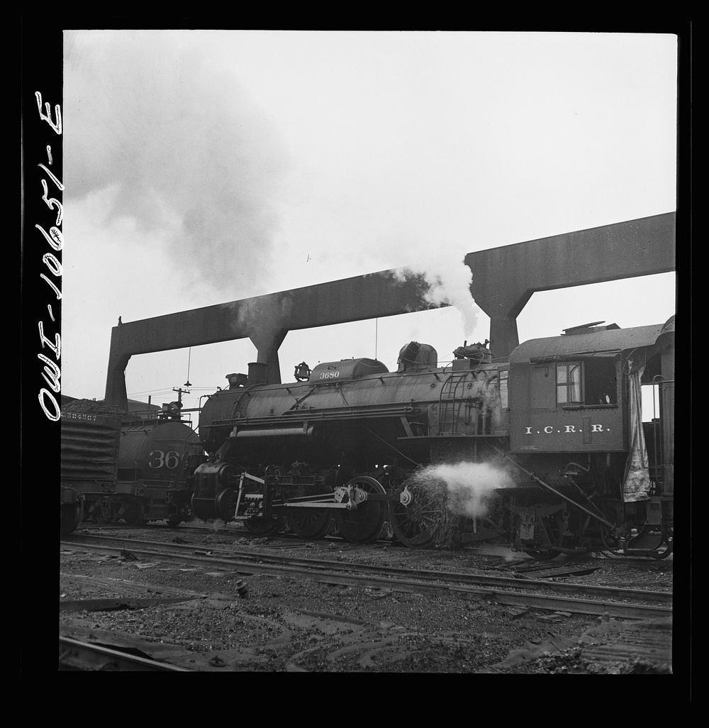 [Untitled photo, possibly related to: Chicago, Illinois. Locomotive taking on sand at an Illinois Central Railroad yard…