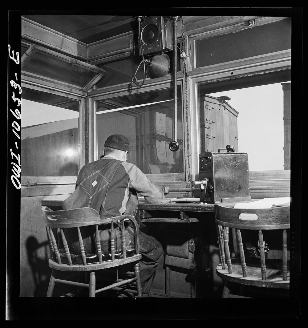 [Untitled photo, possibly related to: Chicago, Illinois. As each car goes by his window at an Illinois Central Railroad…