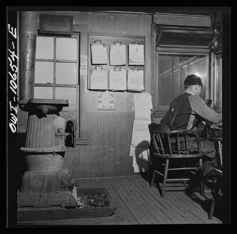 [Untitled photo, possibly related to: Chicago, Illinois. As each car goes by his window at an Illinois Central Railroad…
