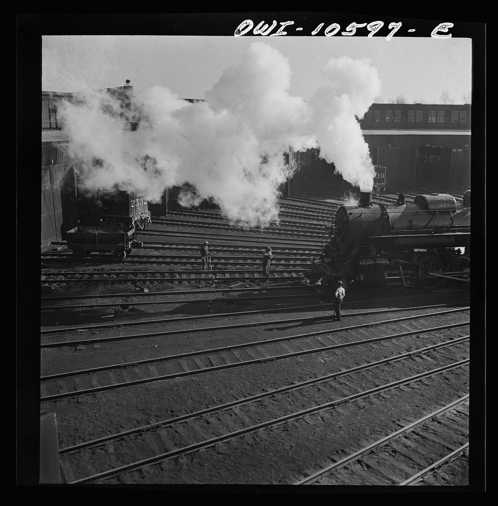 Chicago, Illinois. Engine going into its stall for repairs at the roundhouse at an Illinois railroad yard. Sourced from the…