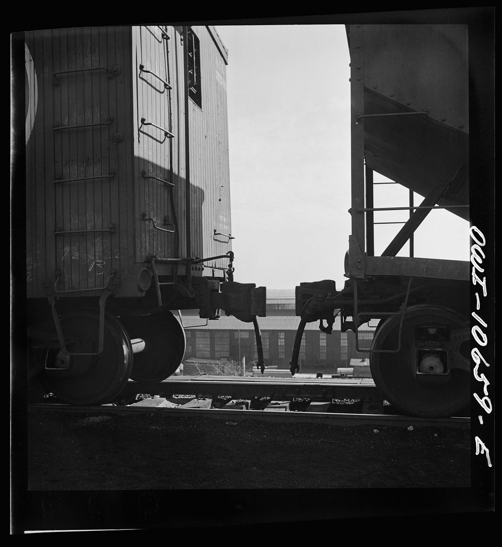 Chicago, Illinois. Cars are uncoupled at the top of the hump and roll down by gravity at an Illinois Central Railroad yard…