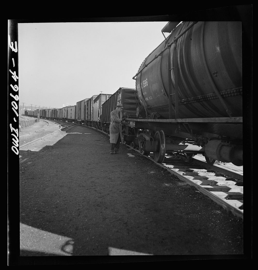Chicago, Illinois. Uncoupling cars as they go over the hump at an Illinois Central Railroad yard. Sourced from the Library…