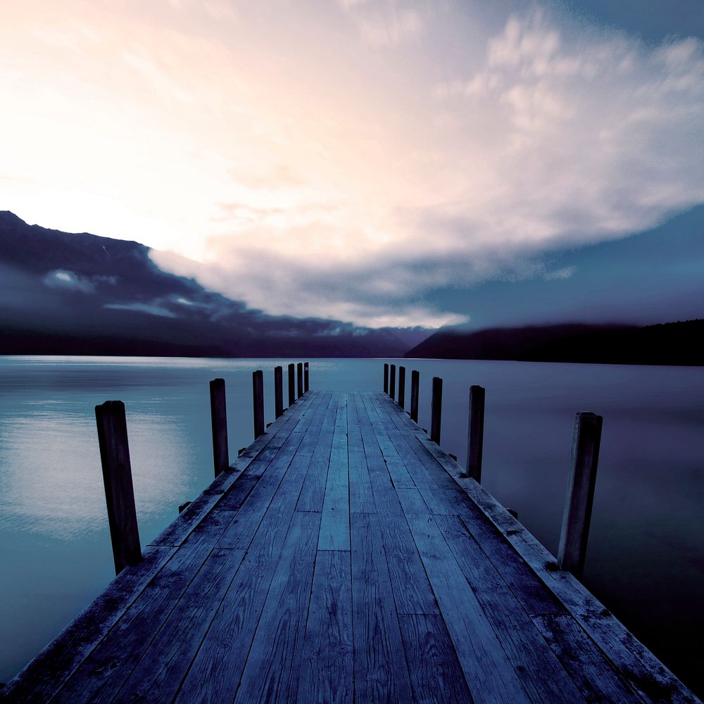 Boat jetty and a calm lake at sunrise, New Zealand.