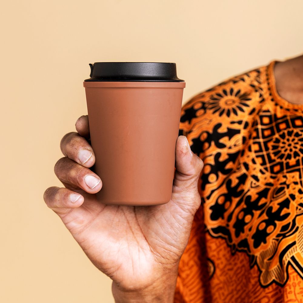 Indian man holding a tumbler