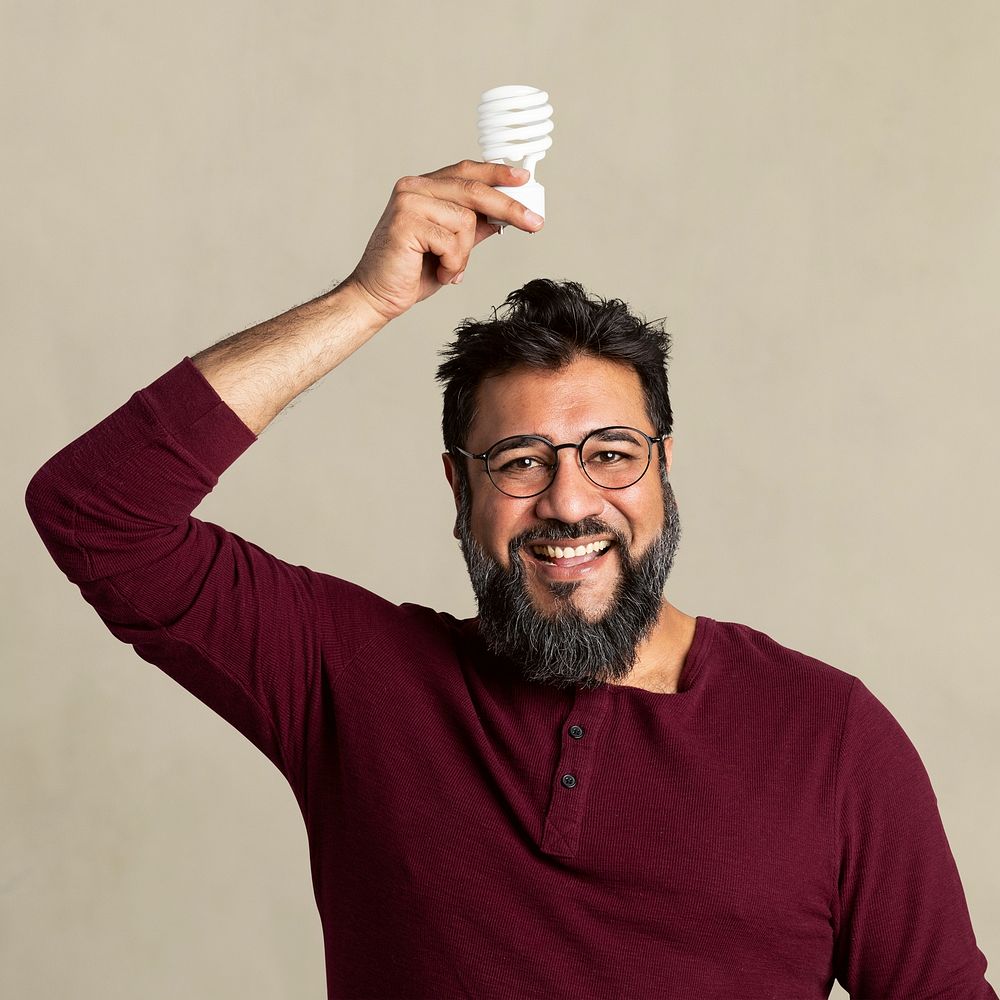 Happy Indian man holding a light bulb mockup 