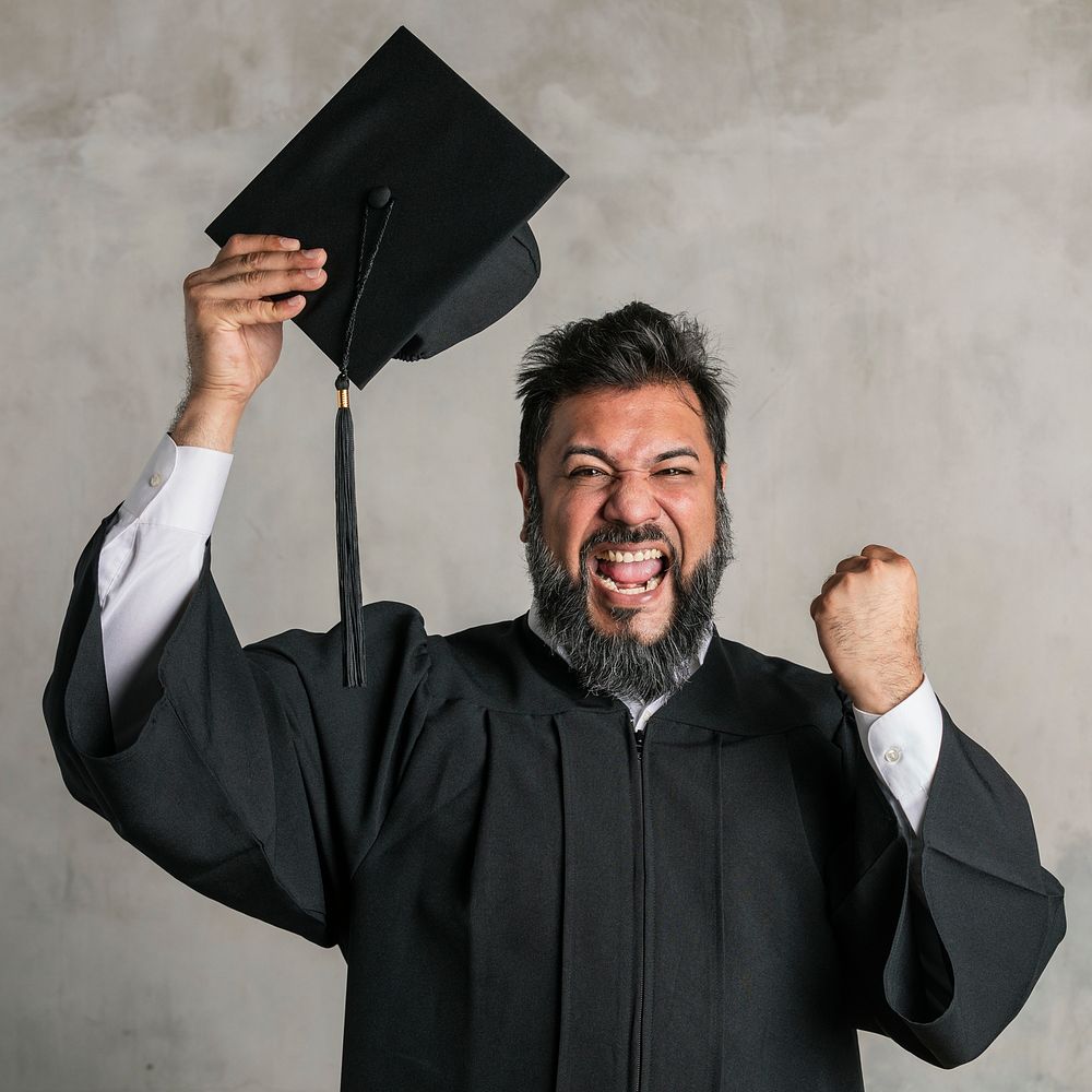 Joyful senior man in a graduation gown 