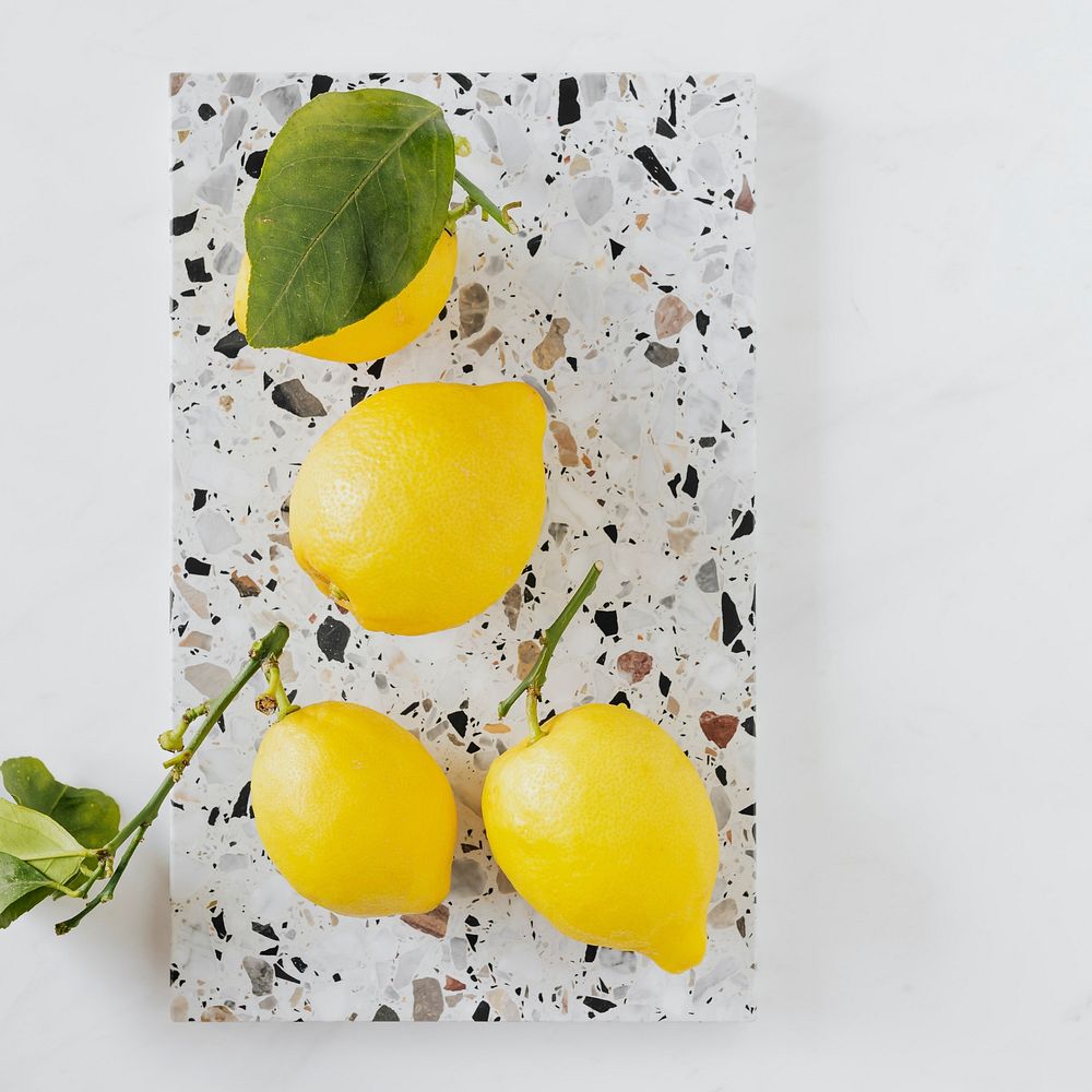 Fresh and organic lemons on a marble chopping board flatlay