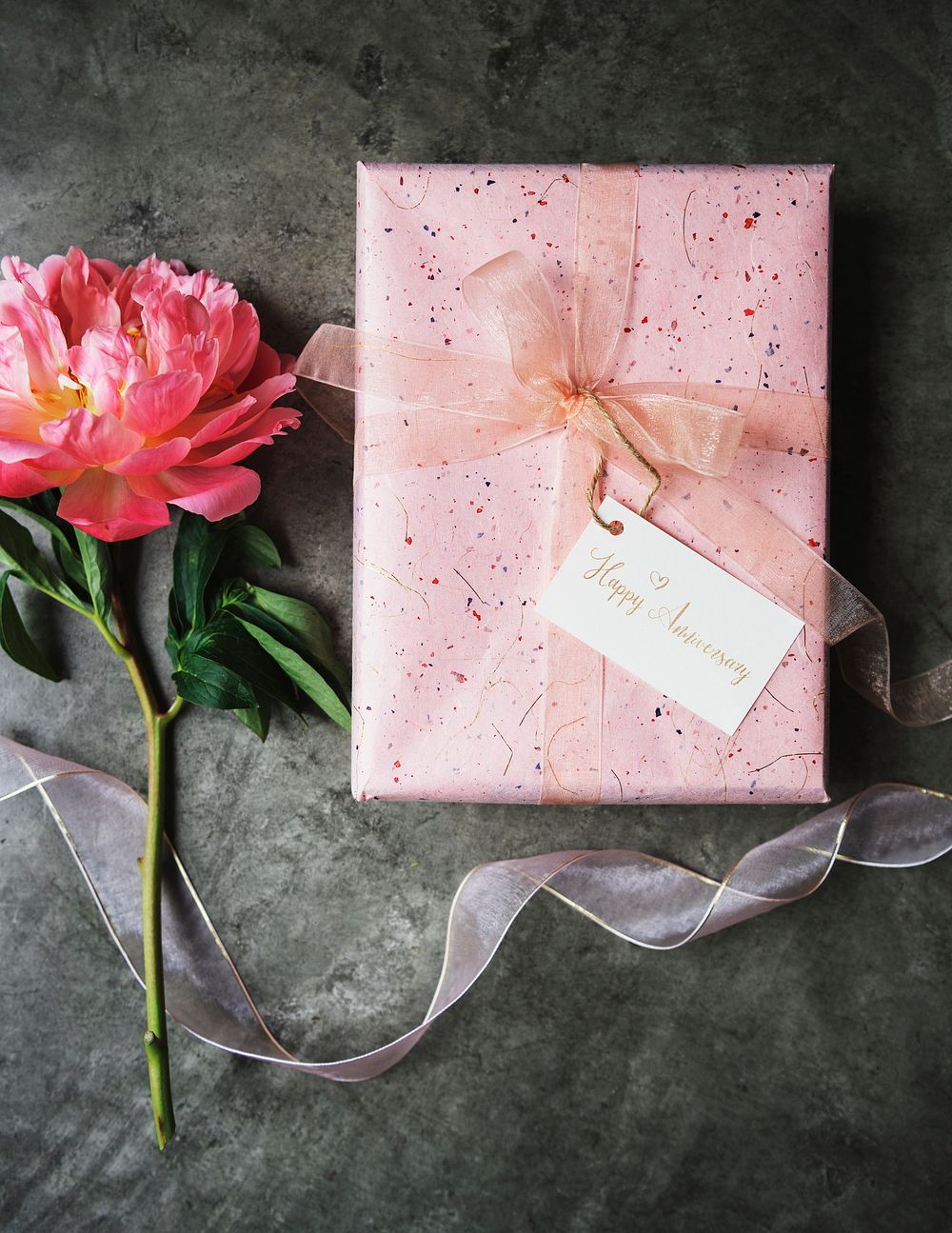 peony coral sunset by a pink anniversary gift box  with a white card mockup