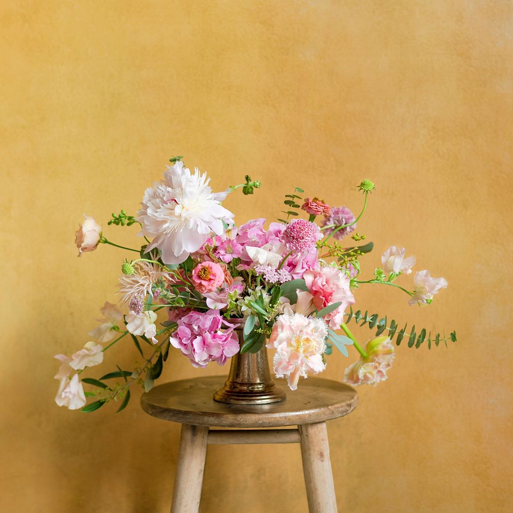 Flowers in a vase on a stool