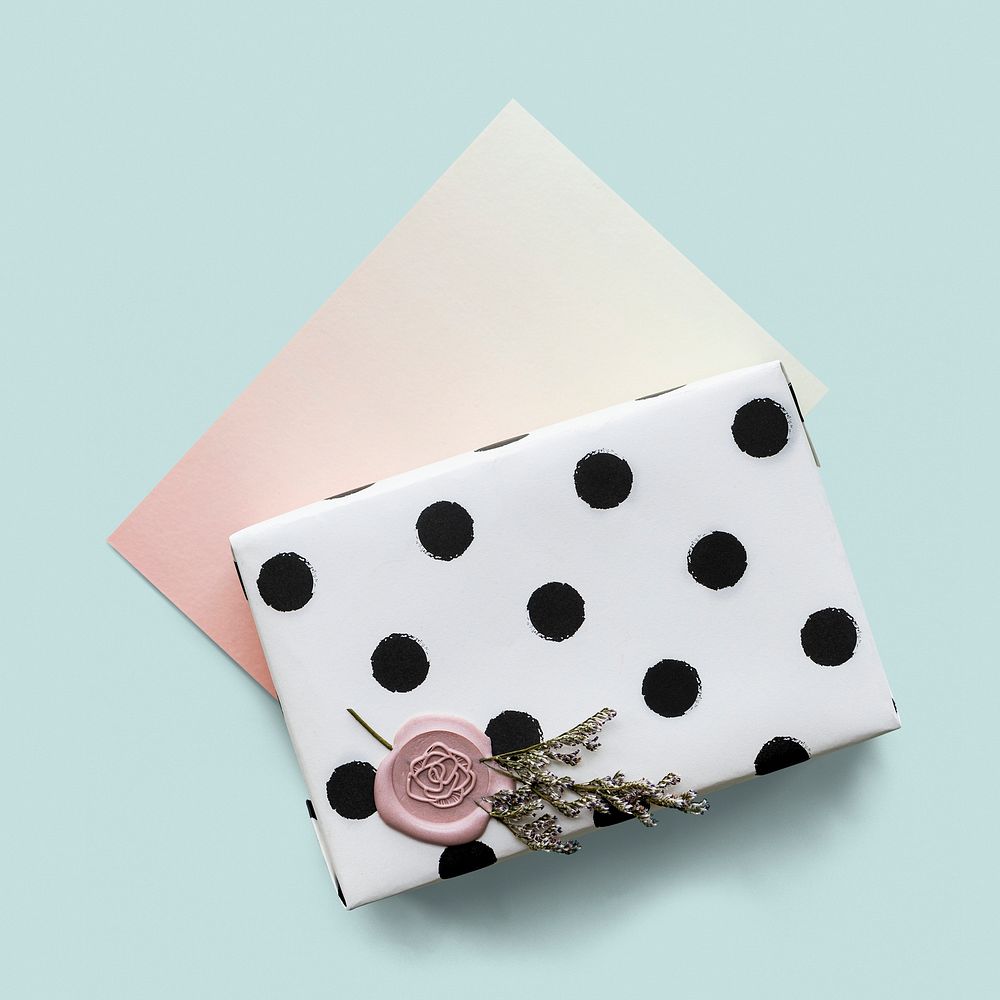 Gift box wrapped with black dots wrap paper