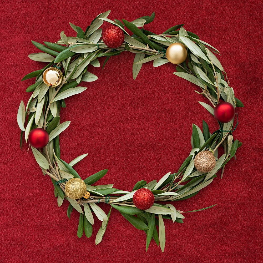 Handmade Christmas wreath decoration on a red fabric background