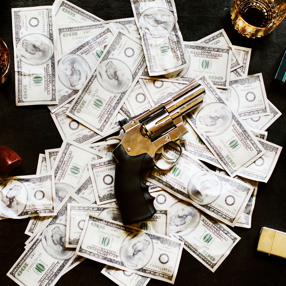 Illegal money and gun on the table
