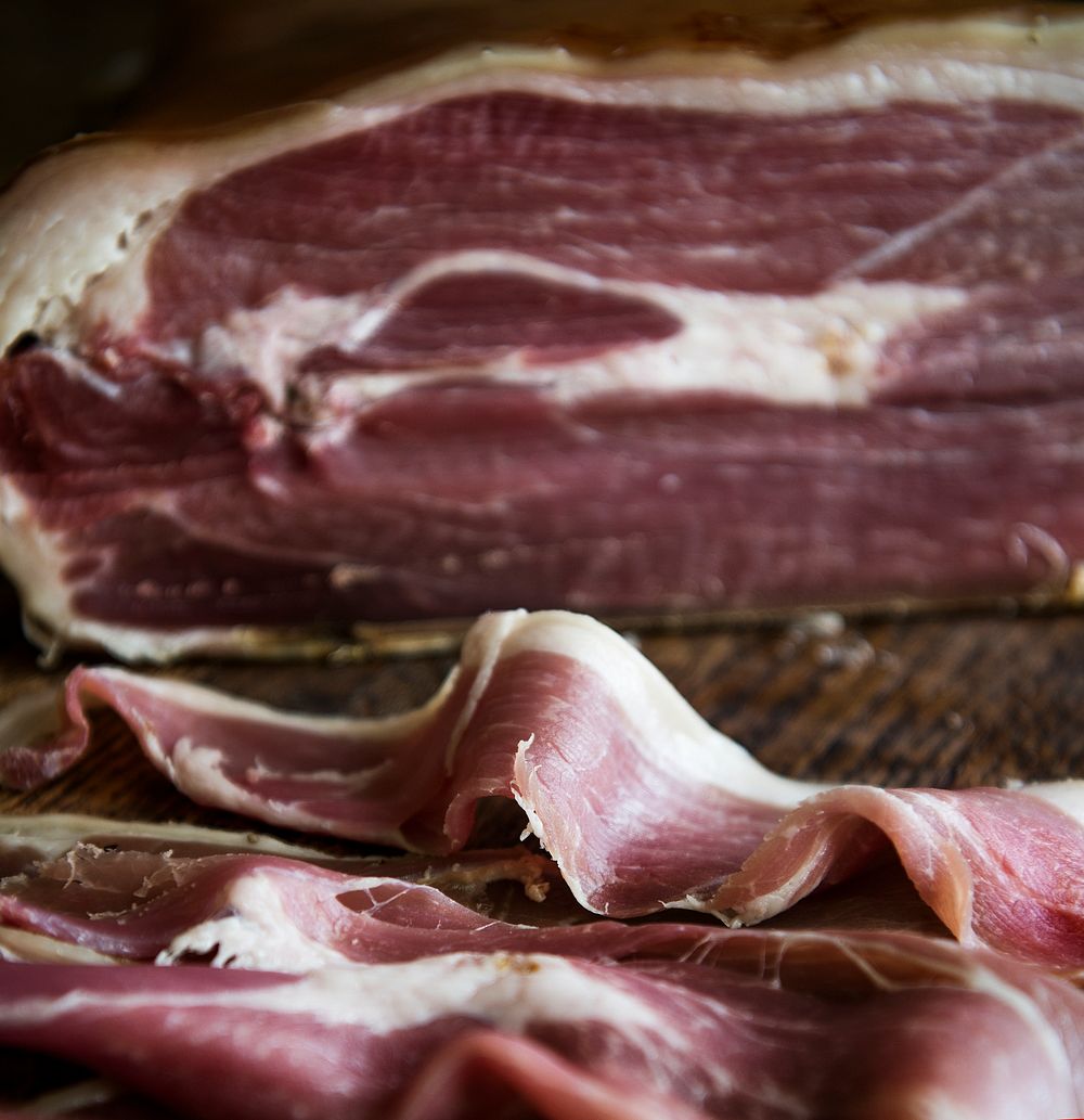 Closeup of dry-cured ham on a wooden table