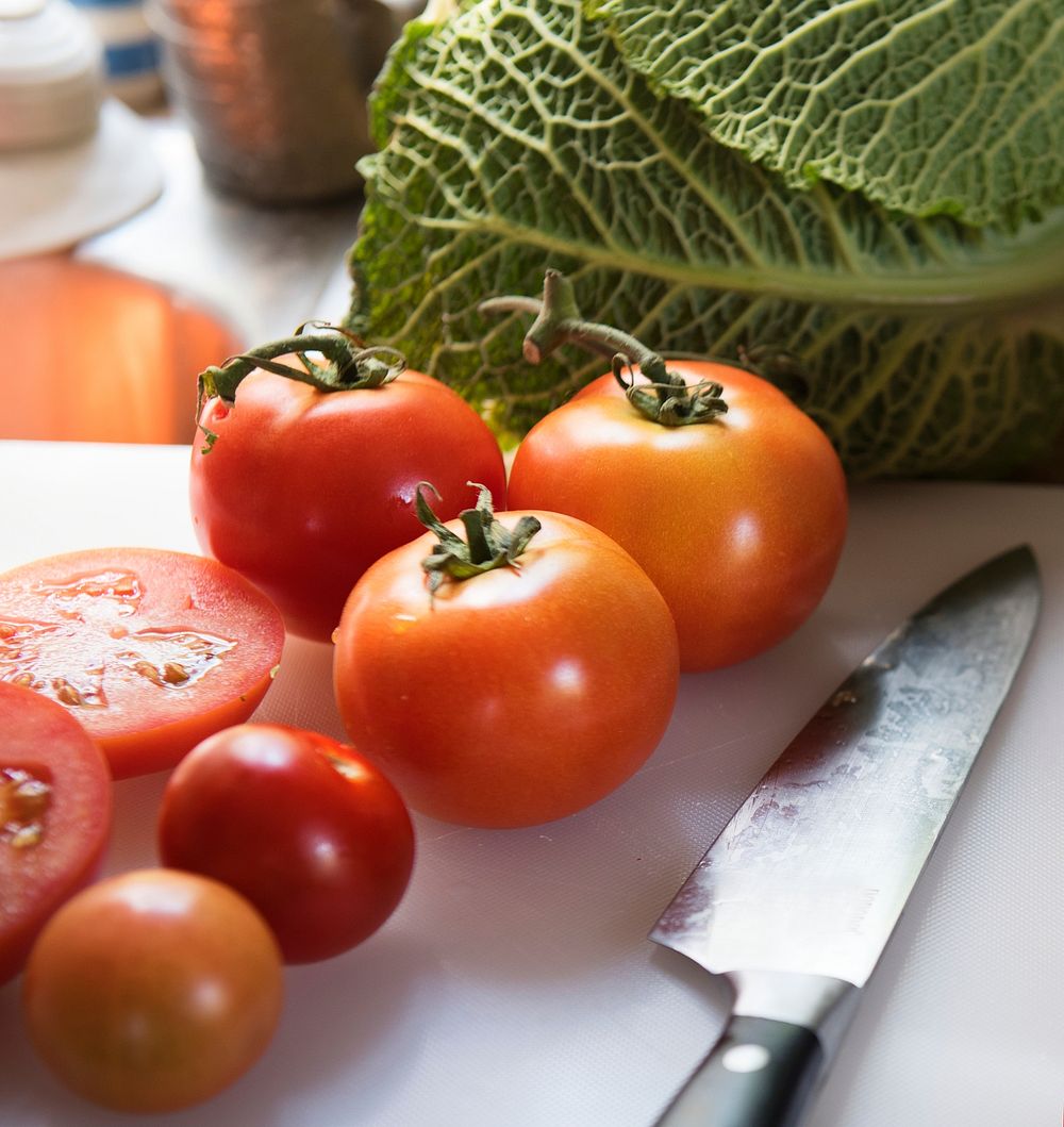 Sliced fresh tomatoes on a cutting board